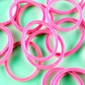 Pink rubber bands on green Royalty Free Stock Photo