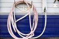 Pink rubber hose against blue wall for vehicle washing