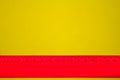 Pink ruler on yellow background