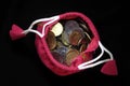 Pink Sack with Indian currency coins. Coin in cotton sack with money. Stacking coin in sack on black background Royalty Free Stock Photo