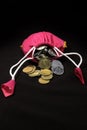 Pink Sack with Indian currency coins. Coin in cotton sack with money. Stacking coin in sack on black background Royalty Free Stock Photo