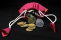 Pink Sack with Indian currency coins. Coin in cotton sack with money. Stacking coin in sack on black background Royalty Free Stock Photo