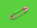 Pink safety pin pierced through green background. Clipping path included Royalty Free Stock Photo