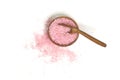 Pink salt in scoop and a wooden bowl isolated on white background. selective focus or blurry. Royalty Free Stock Photo