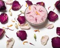 pink salt surrounded by rose petals and white towel on white surface Royalty Free Stock Photo