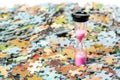 Pink sand hourglass on puzzle pieces background Royalty Free Stock Photo