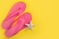 Summer Vibes: Pink Flip Flops and Starfish on Vibrant Yellow Background