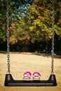 Pink sandals child on swing in the park Royalty Free Stock Photo