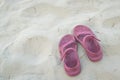 Pink sandals on sandy beach Royalty Free Stock Photo