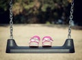 Pink sandals on swing Royalty Free Stock Photo