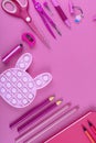 Pink school stationery on a pink background. Creative back to school concept.