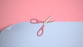 Pink scissor cutting on pastel blue and pink paper