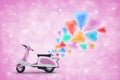 Pink scooter toy with colorful heart love balloon on light pink