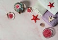 Pink sea salt crystals, towels, burning floating candles, starfish, shells and corals on a pink marble background. Royalty Free Stock Photo