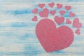 Pink shiny heart on a blue wooden background. view from above. place for text. Valentine`s Day Royalty Free Stock Photo