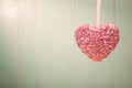 Pink shiny heart on vintage green wood background Royalty Free Stock Photo