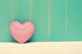 Pink shiny heart on vintage teal wood Royalty Free Stock Photo