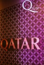 Pink sign with word `Qatar`  at international airport in Doha, Qatar. Bright purple banner with logo `Qatar`. Air travel. Royalty Free Stock Photo