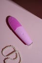 Pink silicone brush, face washing device. Beauty device. Deep cleanser and massager on pink background