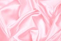 Pink silk satin background. Soft wavy folds on the fabric. Wedding, anniversary, Valentine`s day, celebration. Beautiful pink abst Royalty Free Stock Photo