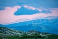 Pink skies and tranquil scenery over mountains in norway during sunset and blue hour Royalty Free Stock Photo