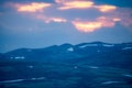 Pink skies and tranquil scenery over mountains in norway during sunset and blue hour Royalty Free Stock Photo