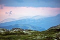 Pink skies and tranquil scenery over mountains during sunset and blue hour Royalty Free Stock Photo