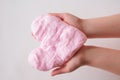 Pink slime or handgum toy in kids hands. fluffy slime DIY project.