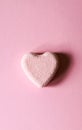 Pink small bath bomb in the shape of heart on pastel background Royalty Free Stock Photo