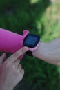 Pink Smartwatch Phone o nLittle girl& x27;s Hand. Kid Using pink Intelligent Phone. Summer time Otside. Royalty Free Stock Photo