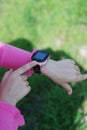 Pink Smartwatch Phone o nLittle girl& x27;s Hand. Kid Using pink Intelligent Phone. Summer time Otside. Royalty Free Stock Photo