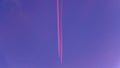 Pink smoke plane trail in a blue sky above Tetouan city in Morocco Royalty Free Stock Photo