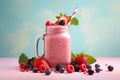 Pink smoothie surrounded by berry fruits