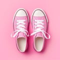 Pink sneakers on pink background.
