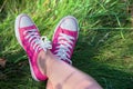 Pink sneakers on girl legs