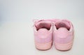 Pink sneakers shoes with shoelace rear view on floor soft focus with copy space