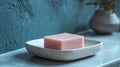 Pink soap bar on a ceramic dish in a bathroom Royalty Free Stock Photo