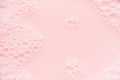 Pink soap bubbles and pink water as cute youth abstract background, copy space.