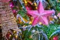 Pink soft star hanging as decoration on a snow covered Christmas tree, close-up Royalty Free Stock Photo