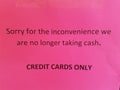 Pink sorry for the inconvenience we are no longer taking cash credit cards only sign Royalty Free Stock Photo