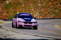 Pink sparkly BMW F3 on a curve in Pasadena, USA