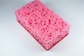 Pink sponge for washing dishes on white background. Artificial fiber not eco-friendly tool. Things for kitchen Royalty Free Stock Photo