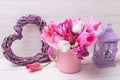Pink spring tulips flowers in pink cup, violet decorative hea Royalty Free Stock Photo