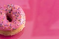 A Pink Sprinkle Donuts on a Pink Background