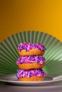 Pink sprinkle donuts in a spotlight, art nouveau style background