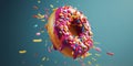 Pink sprinkled doughnut hovering against a bluish background.