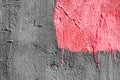 Pink square with peeling paint on gray plastered wall background. Grunge texture. copy space