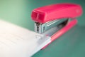 Pink stapler does not pierce through many sheets of paper.shallow focus effect