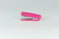 Pink stapler isolated on grey background Royalty Free Stock Photo