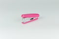 Pink stapler isolated on grey background Royalty Free Stock Photo